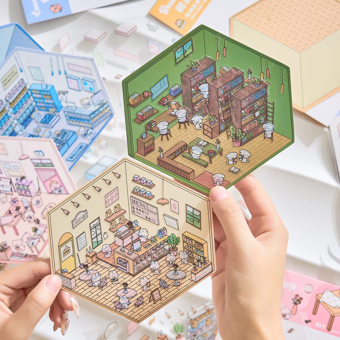 Hands holding two finished palm-sized hexagon rooms